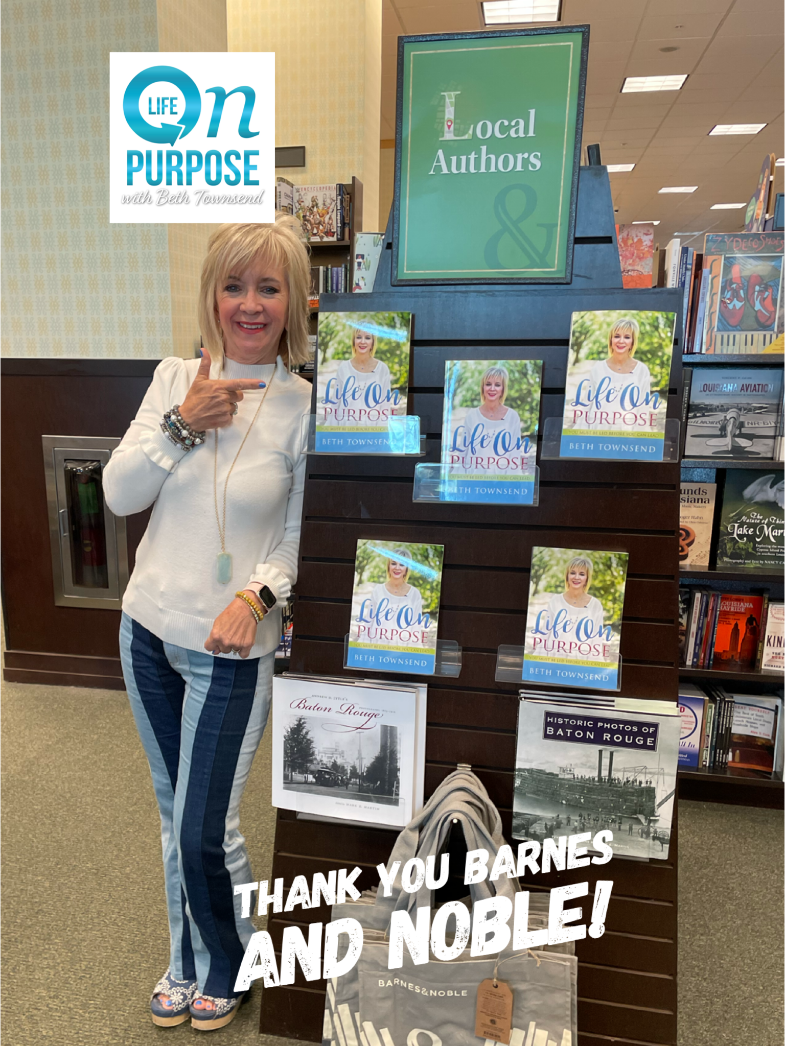 Beth Townsend pointing at her books in the Barnes & Noble Local Authors display